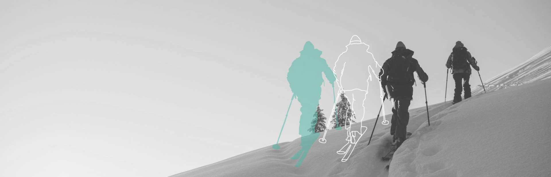 Two splitboarders hiking on top of the mountain