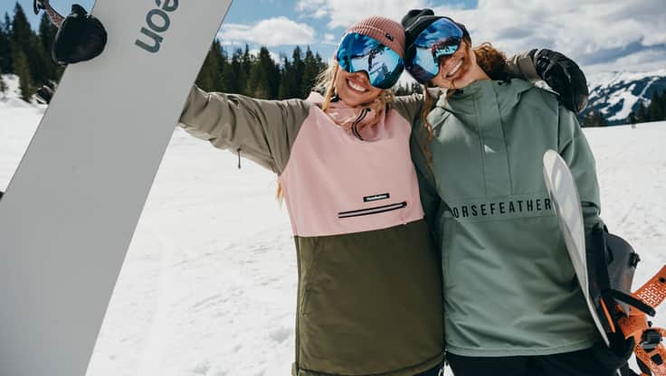 Snowboarder con giacca a taglio lungo