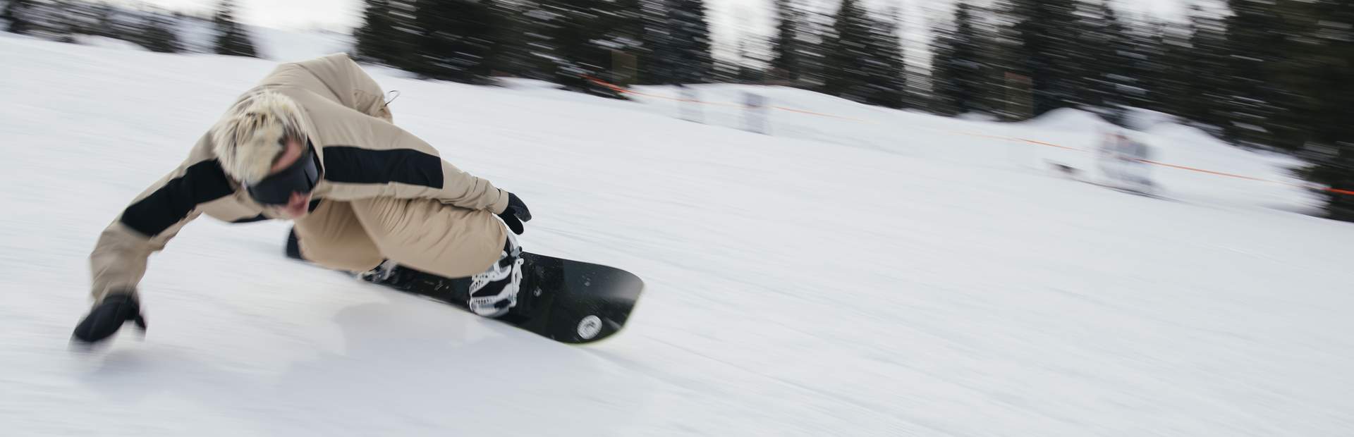 Snowboarding pupils following each other on the slope